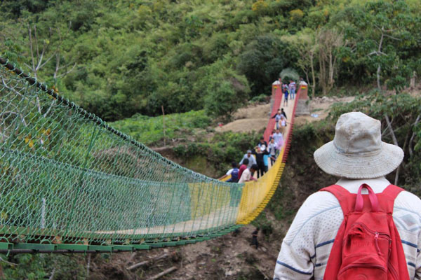 2e_Bridge Bolivia Students walking on a bridge in Bolivia