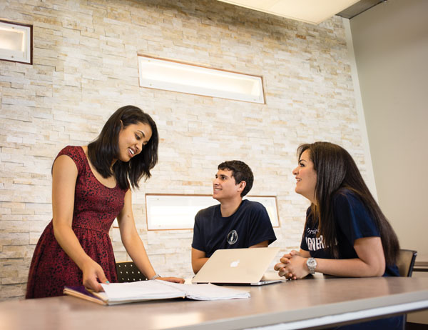 Students meet to run through a group presentation before class.